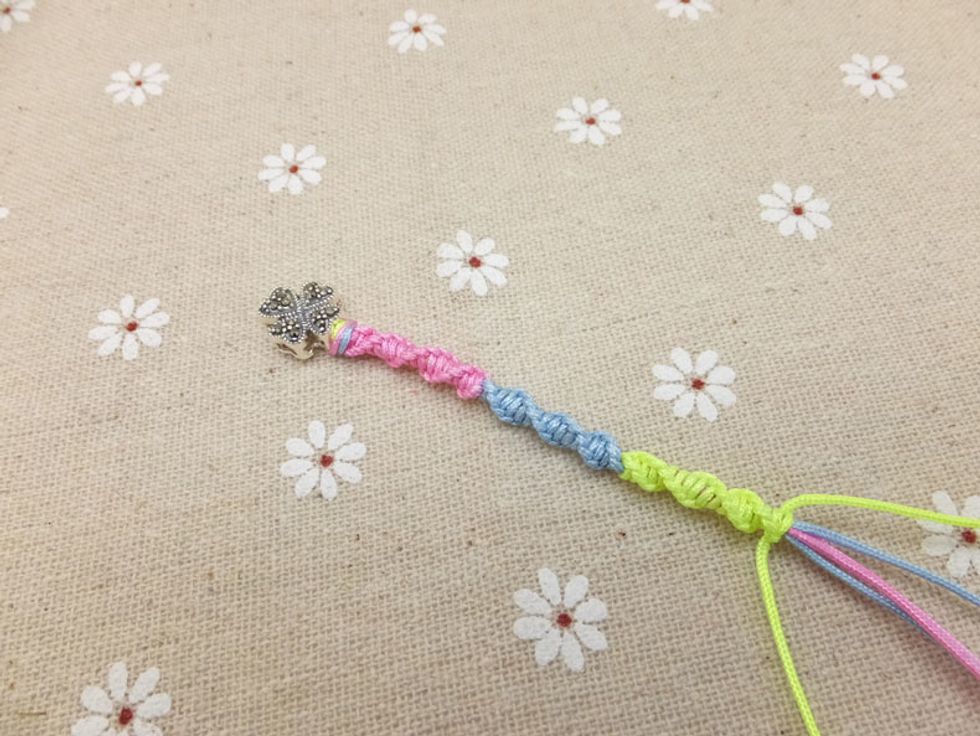 Again, pull the gold yellow cord and continue braiding bracelet by using the above method.