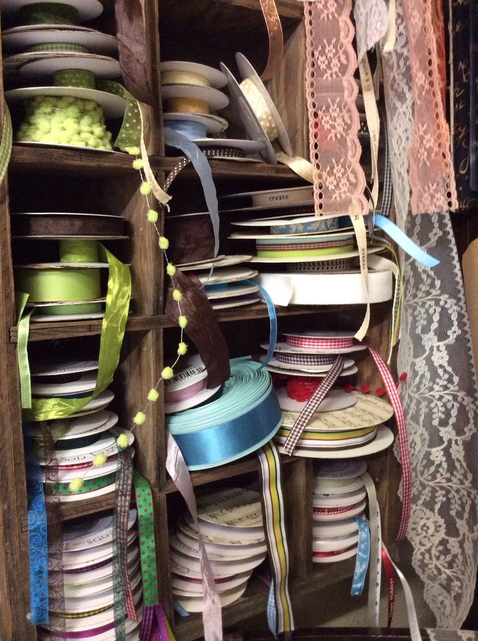 Again...the divided box/caddy comes into play. This time hung on the wall for handy ribbon roll storage.