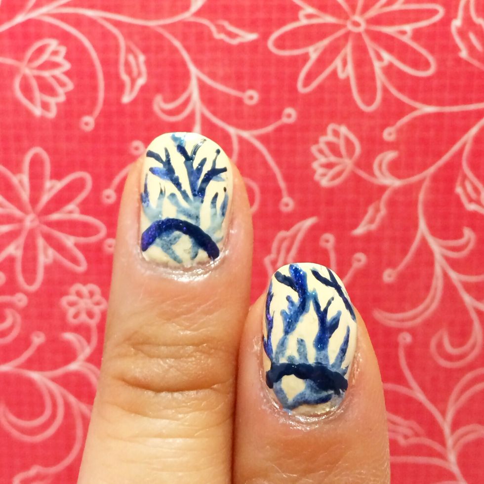 Again, using the darker blue polish create an dark outline of a half moon. (optional step)