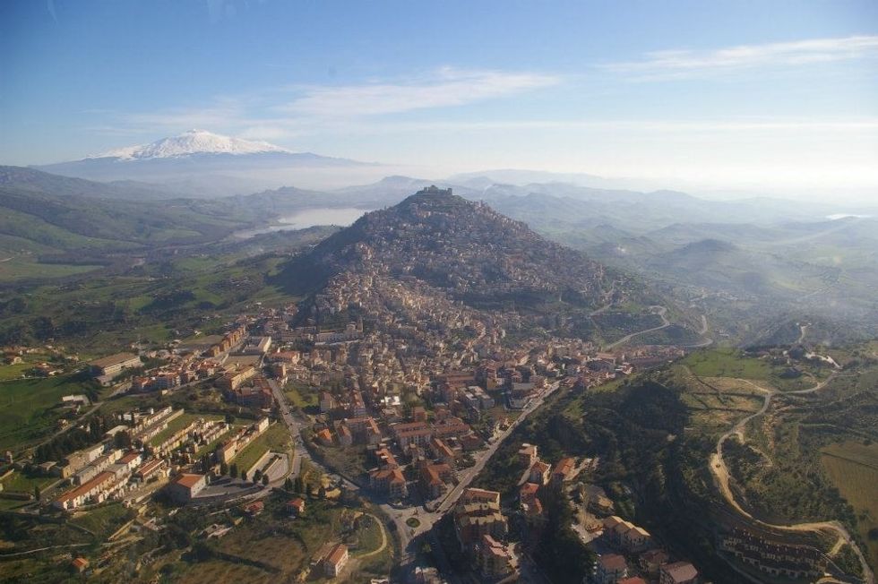 Agira today, aerial view. In the background the Pozzillo Lake and Mount Etna.