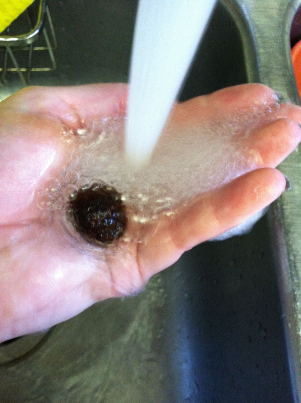 Agitation really builds up a lot of suds. The soapy roving may seem super slippery so go ahead and rinse it to remove the suds. Add another drop of soap and continue rolling the bead.