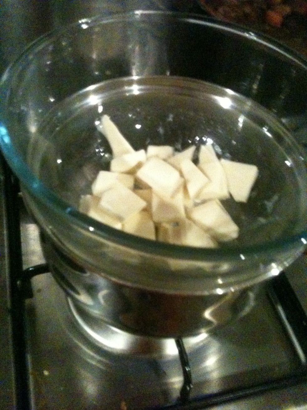 Aight, bitchin' new apron aside- set up a saucepan with a bit of water and get it to simmering level. Place a DRY bowl on top (not touching the water) and fill it with the chopped up chocolate.