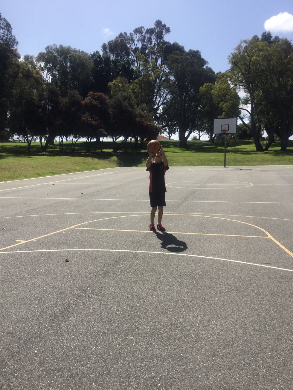 Aim the ball at the back of the rim, and flick the ball towards the hoop.