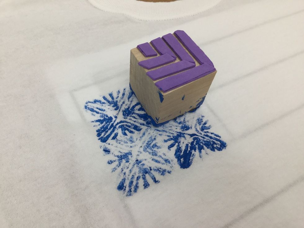 Align block as desired, press down and then lift off gently. You may stamp again for a lighter print, or add more paint for a darker print. Repeat with other design until the flag shape is complete.