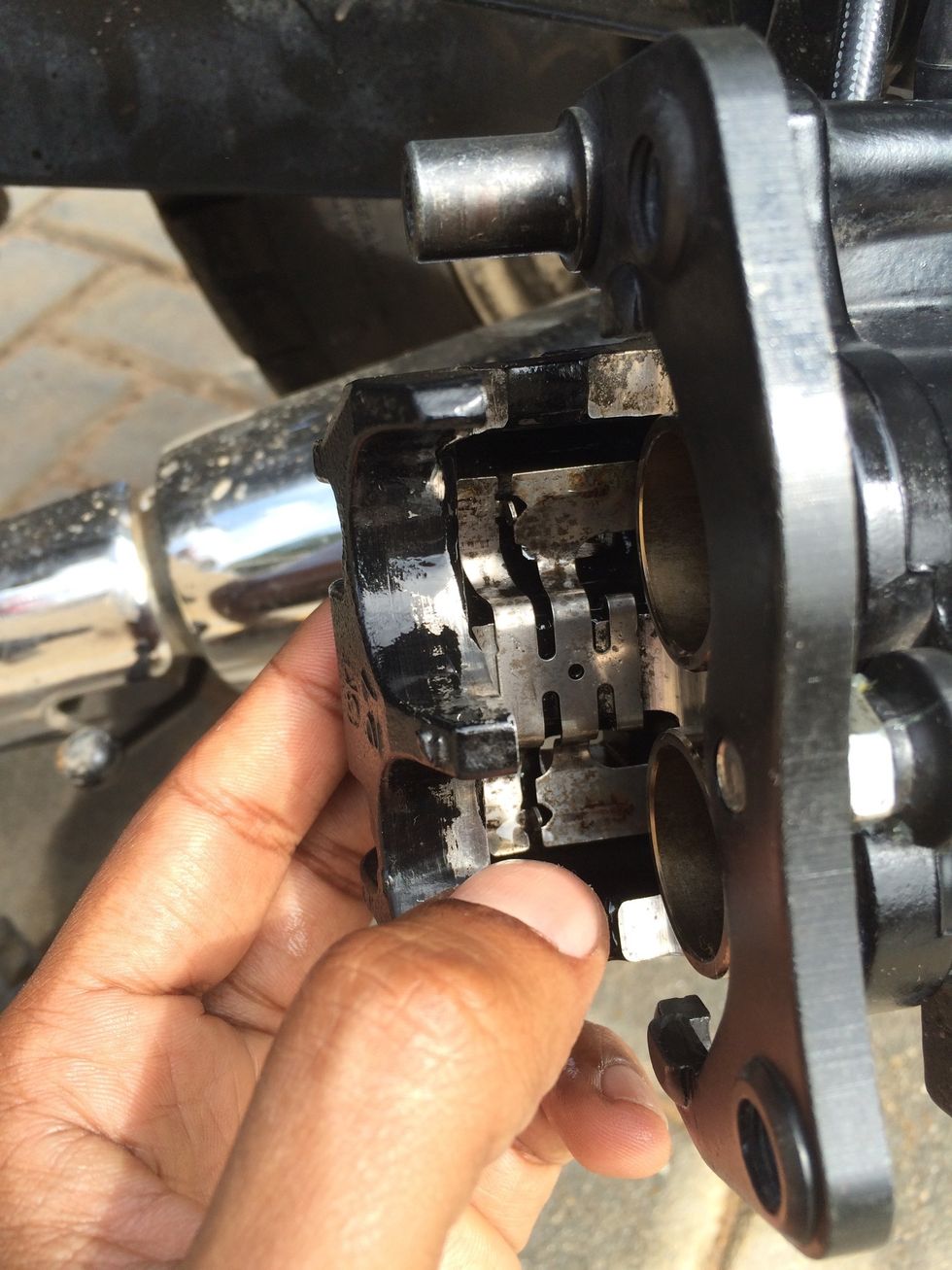 Align the flat spring back ( note the way it goes in - the small hook that retains the flat spring is towards the pistons )