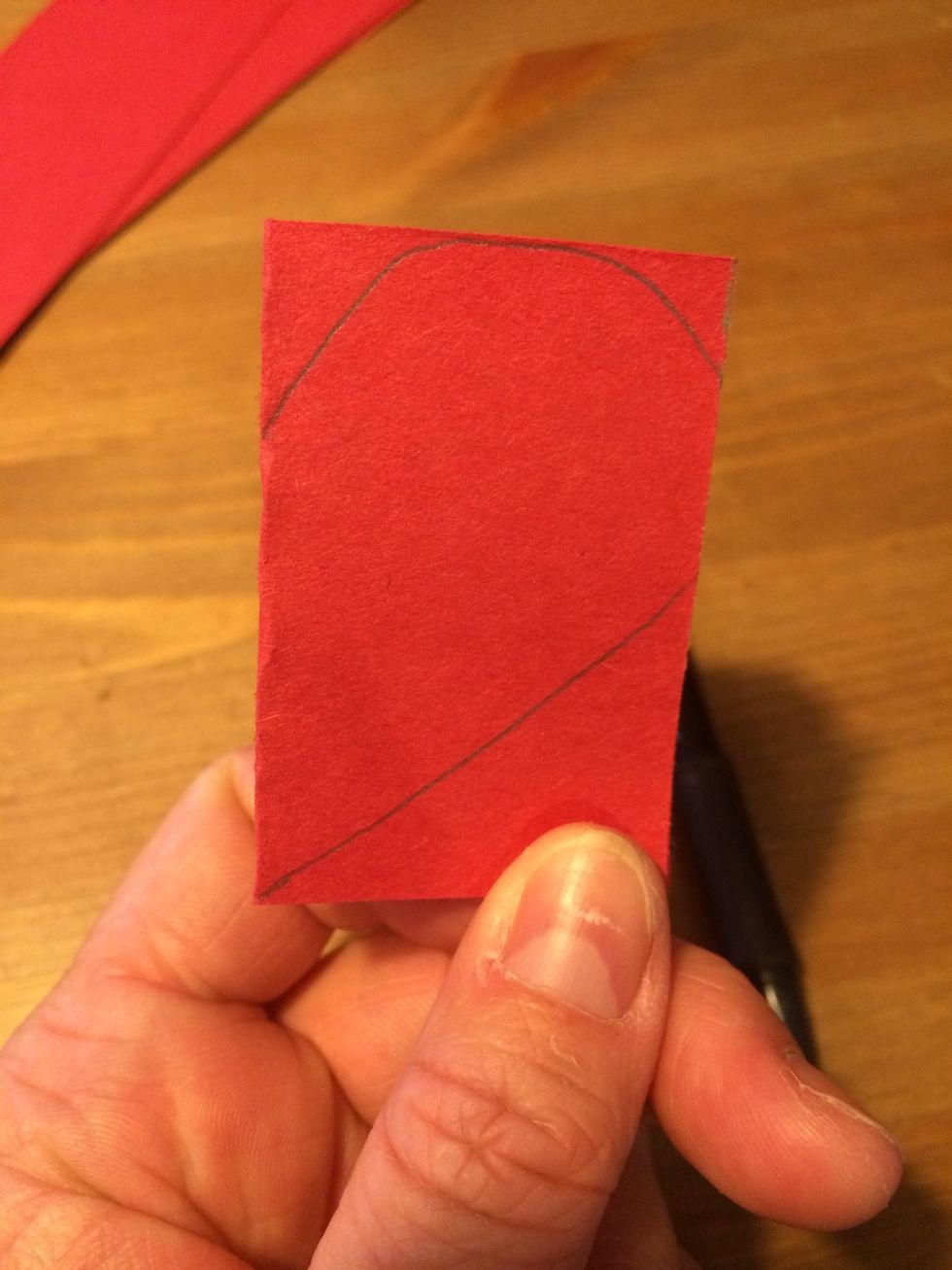 Align the paper so the fold is to the left. Draw a half heart, with the center of the heart on the left folded edge. The top should reach the top edge and the right edge is what will NOT be cut.