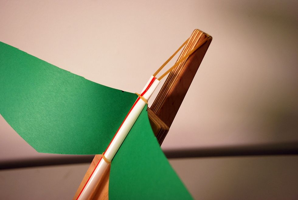 Align the rubber band with the notch at the end of the launcher.