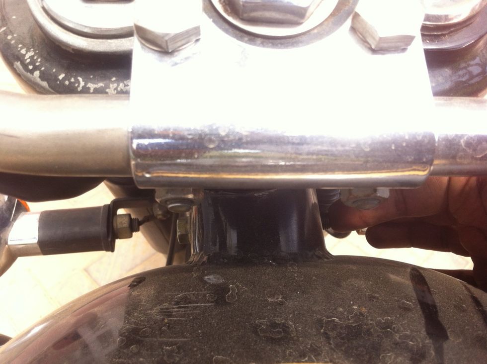 Aligning the tank so the bolt can be pushed out easily without damaging the threads.