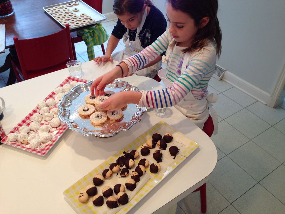 All finished! Hadley gets started putting the cookies on the tray. It's a beautiful circle.
