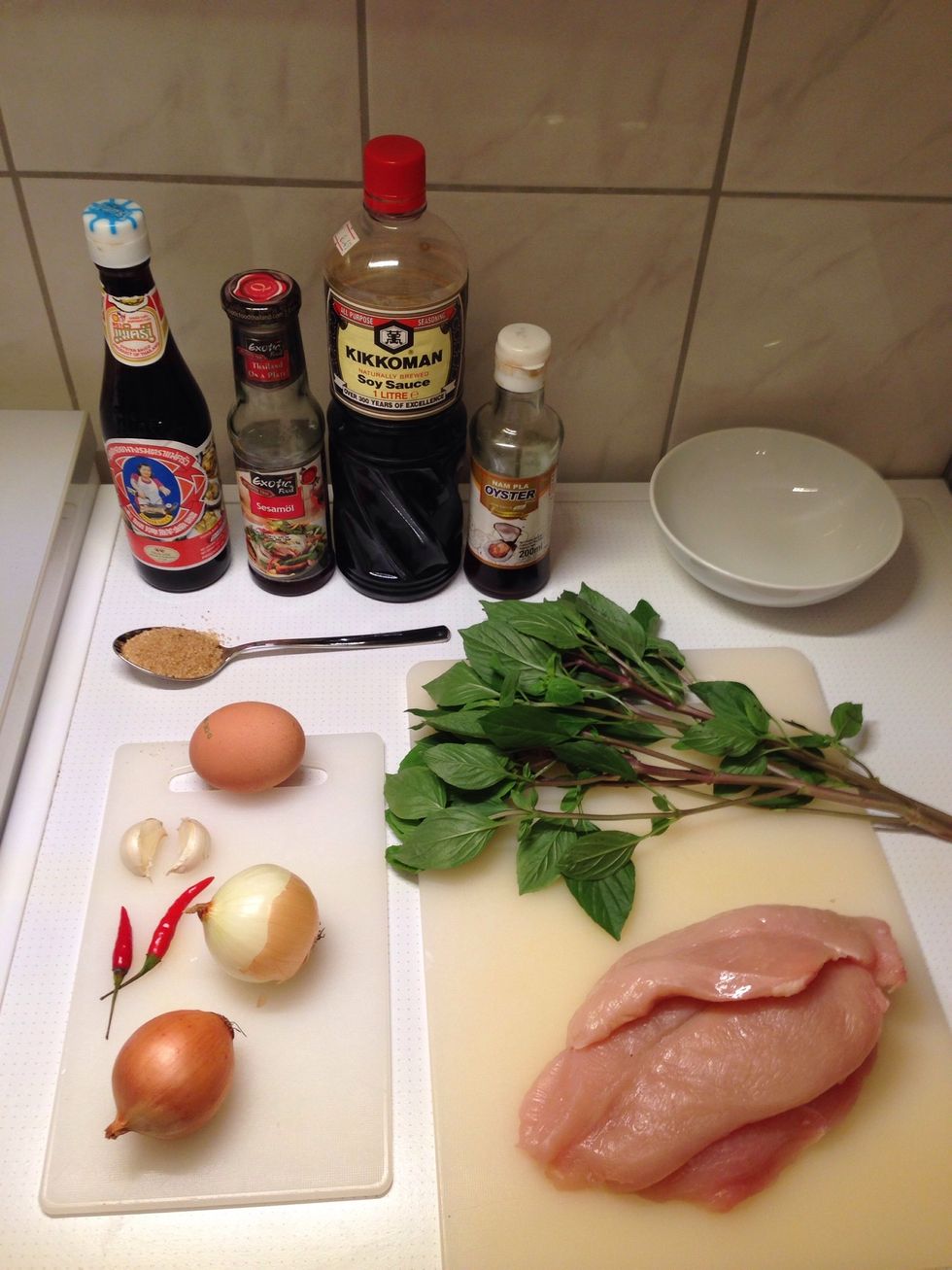 All ingredients (except for the peanut oil): 1. Chop and dice the chicken 2. Peel and slice Onions roughly 3. Chop chillies and garlic 4. Pluck the Thai Basil