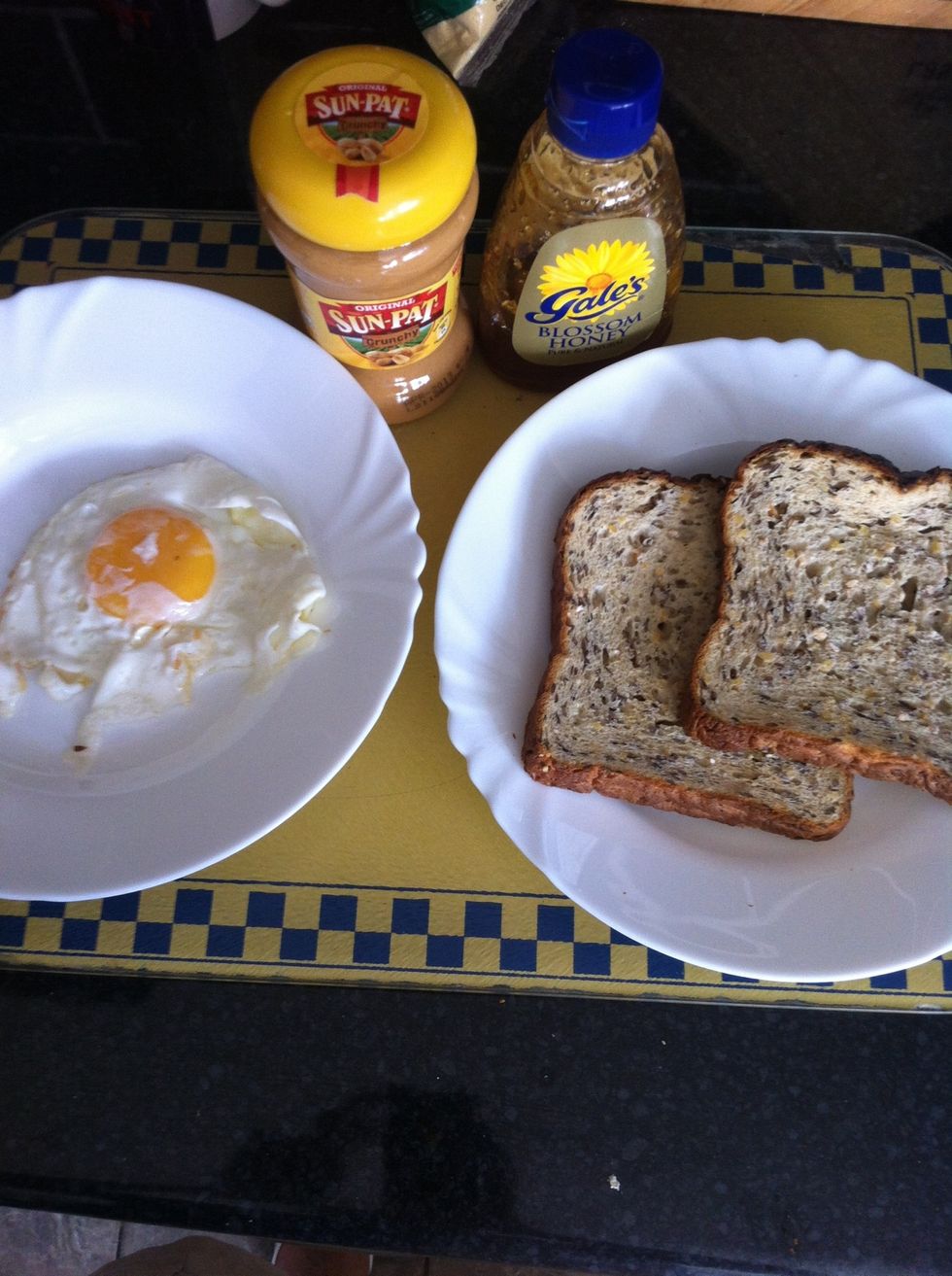 All the ingredients required. Fry the egg and toast the slices of bread.