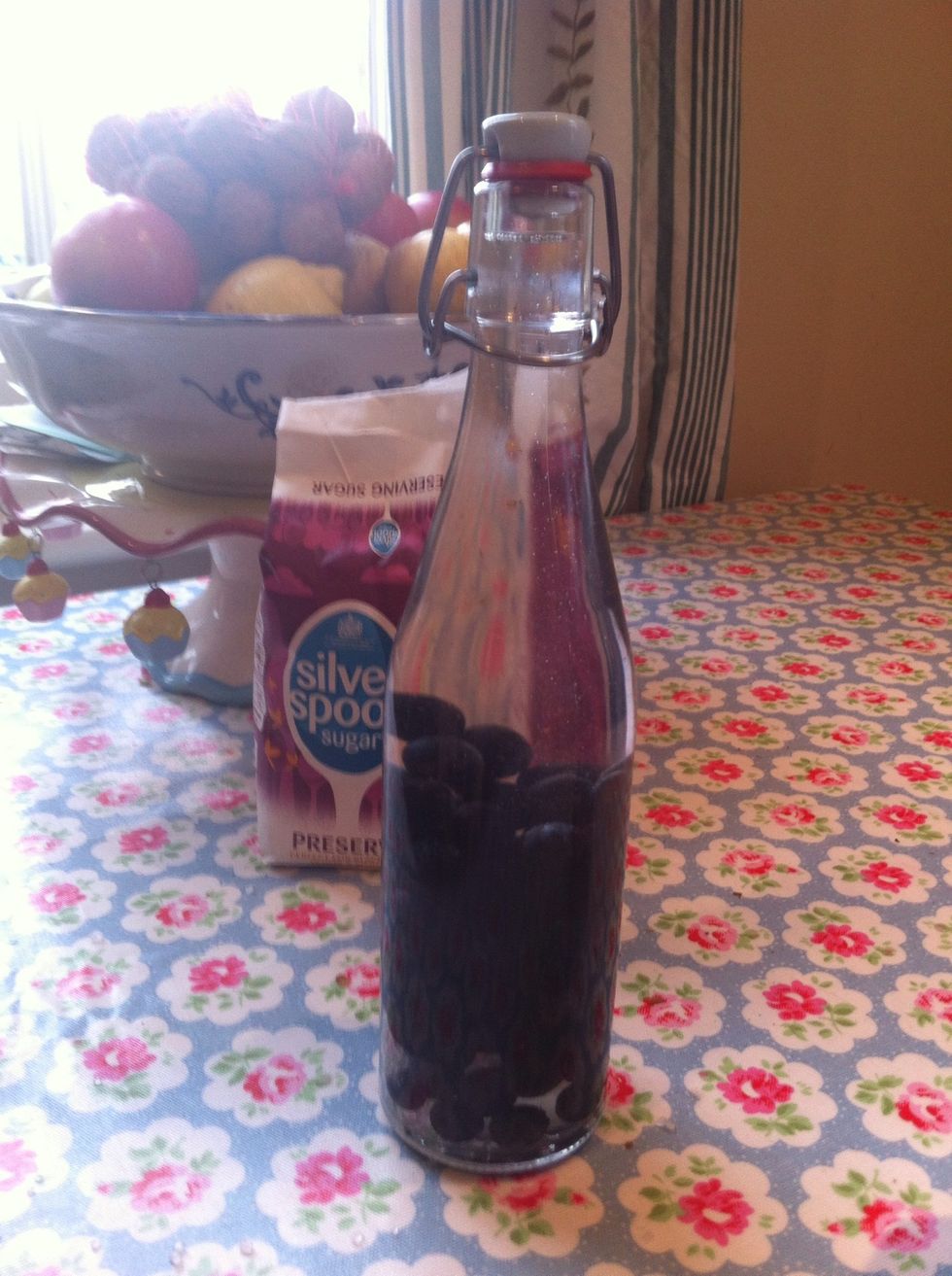 All the sugar will now have fallen to the bottom. Place the bottle in a dark cupboard and shake every other day until all the sugar dissolves.