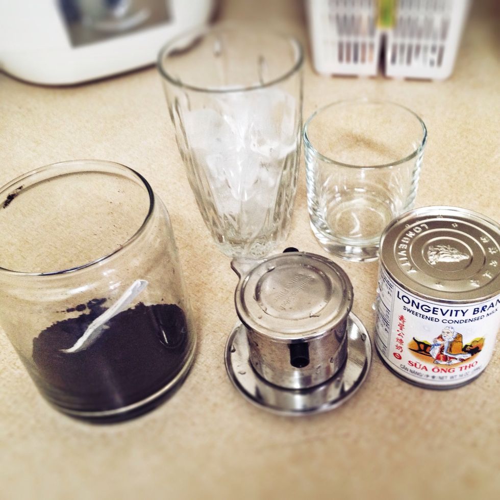 All you need. Coffee ground, 1 large cup with ice, 1 small cup, Vietnamese coffee filter, and sweetened condensed milk.