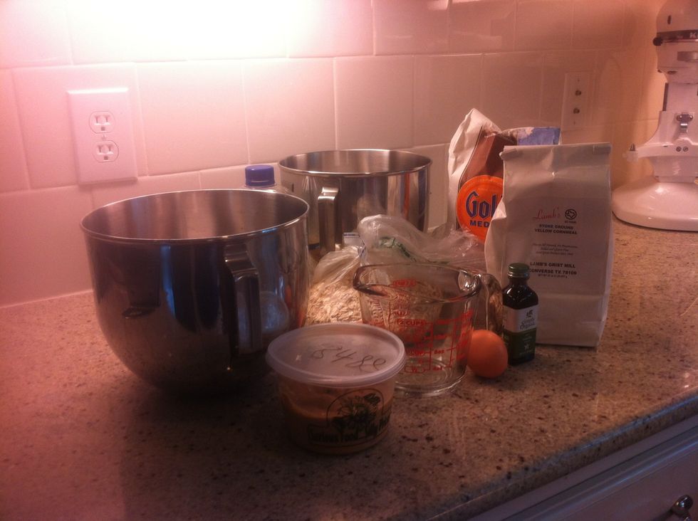 All you will need is a measuring cup, eggs cornmeal, peanut butter, vanilla, oats, olive oil, flour, and water.