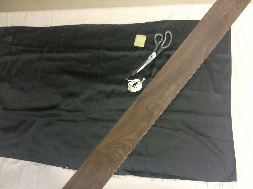 Allocate the black satin cloth with pair of scissors, marking chalk, measuring scale to pre measure and cut the strips in quantity.