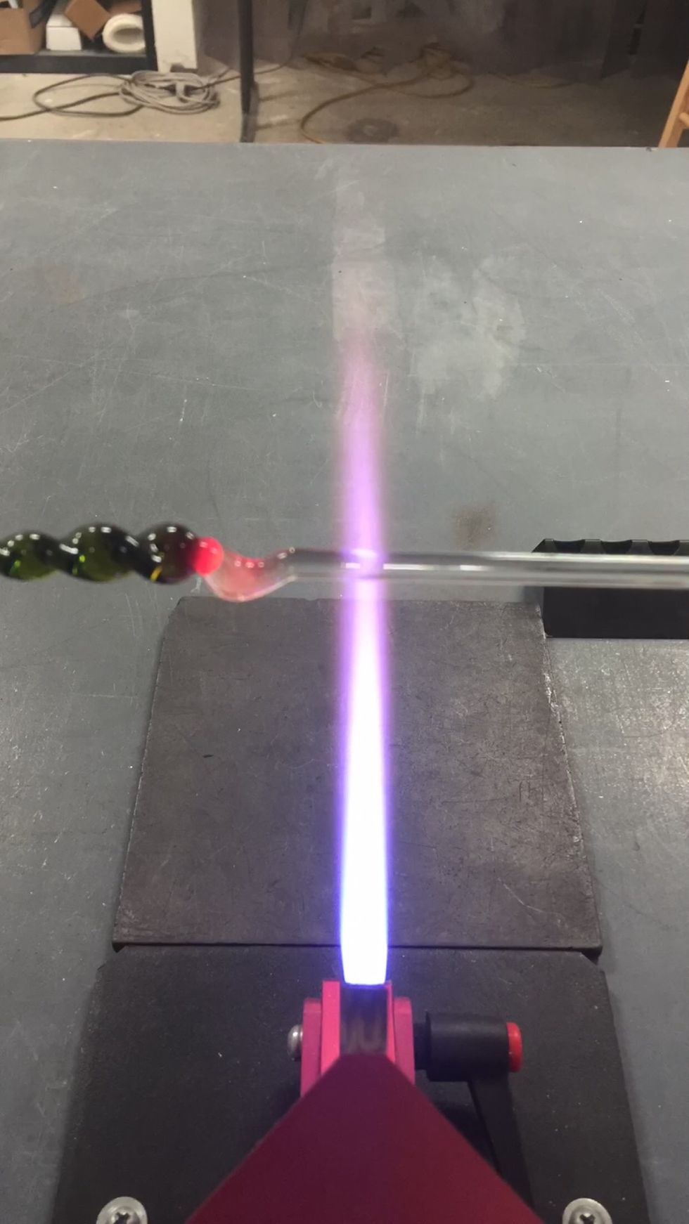 Allow the clear gather to cool a little outside the flame, then stretch it a bit and let it droop.