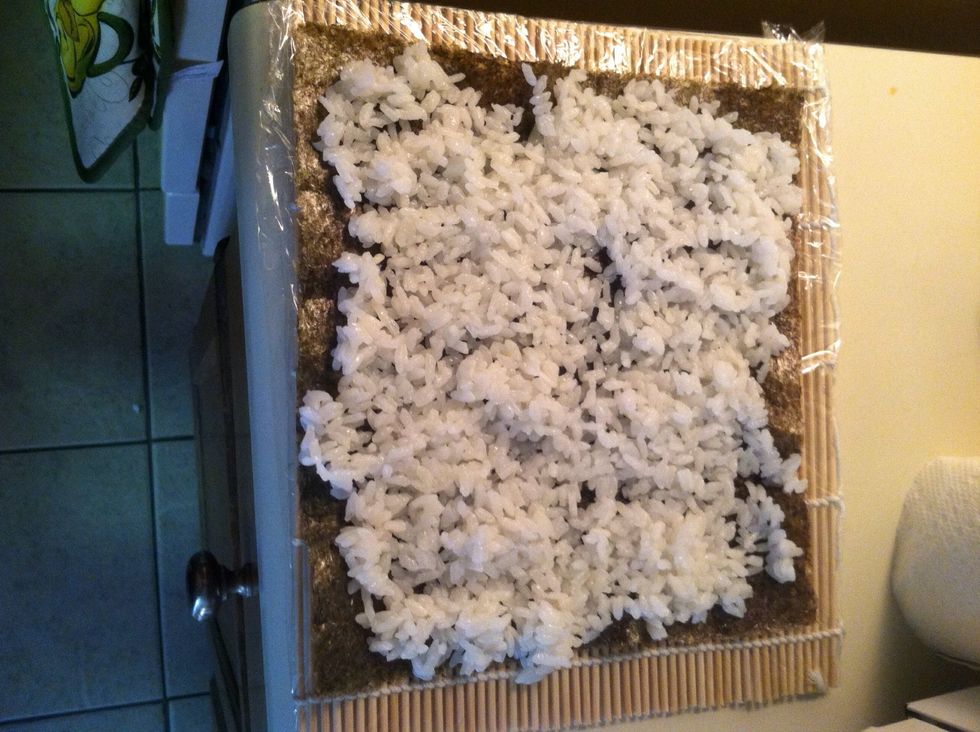 Allow the rice to cool to room temp before spreading. (If in a hurry you can stick it in the fridge for 5 mins) spread an even layer on the seaweed. You can flip it to have the rice on the outside.