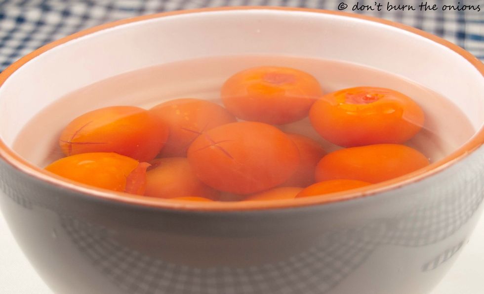 Allow tomatoes to rest in water for 1 minute then check to see if skin pulls away easily. If not, wait another 30 seconds or so. The riper the tomato the easier the skin will come away.