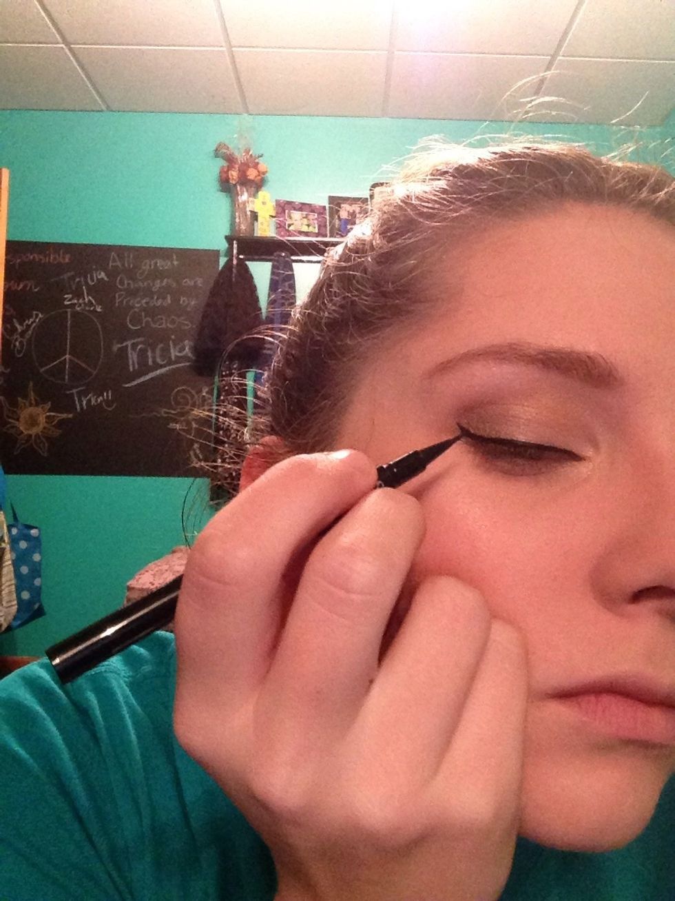 Almost done! Take your liquid eyeliner to create a perfect wing. Start from the outer corner of you eye to make the base of the wing, then follow above the lashes a crossed your lid.