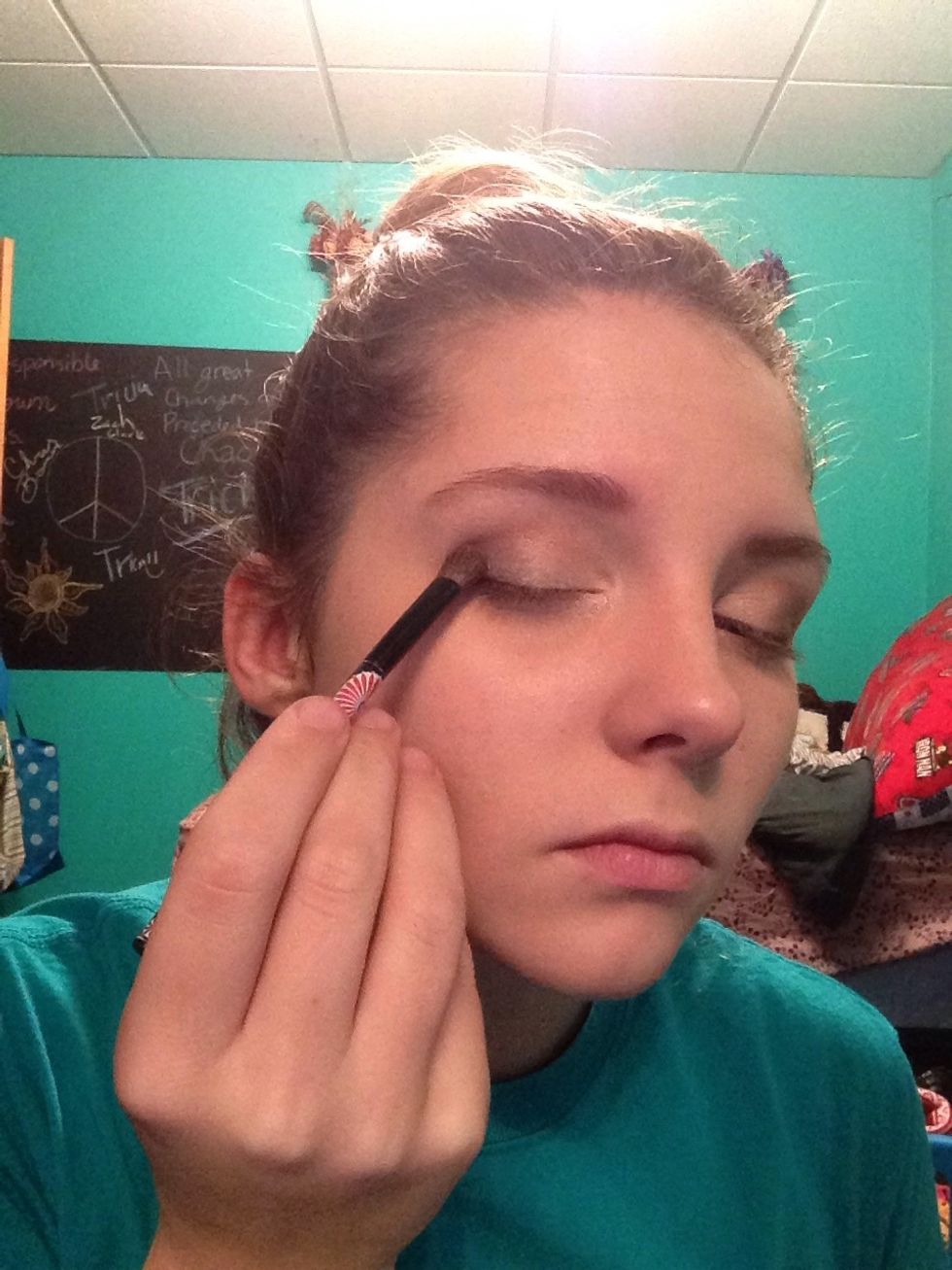 Almost done with eyeshadow! Take a bigger eyeshadow brush and dab it in the dark shadow. Brush the shadow from about mid eyelid to the outer corner of your eyelid.