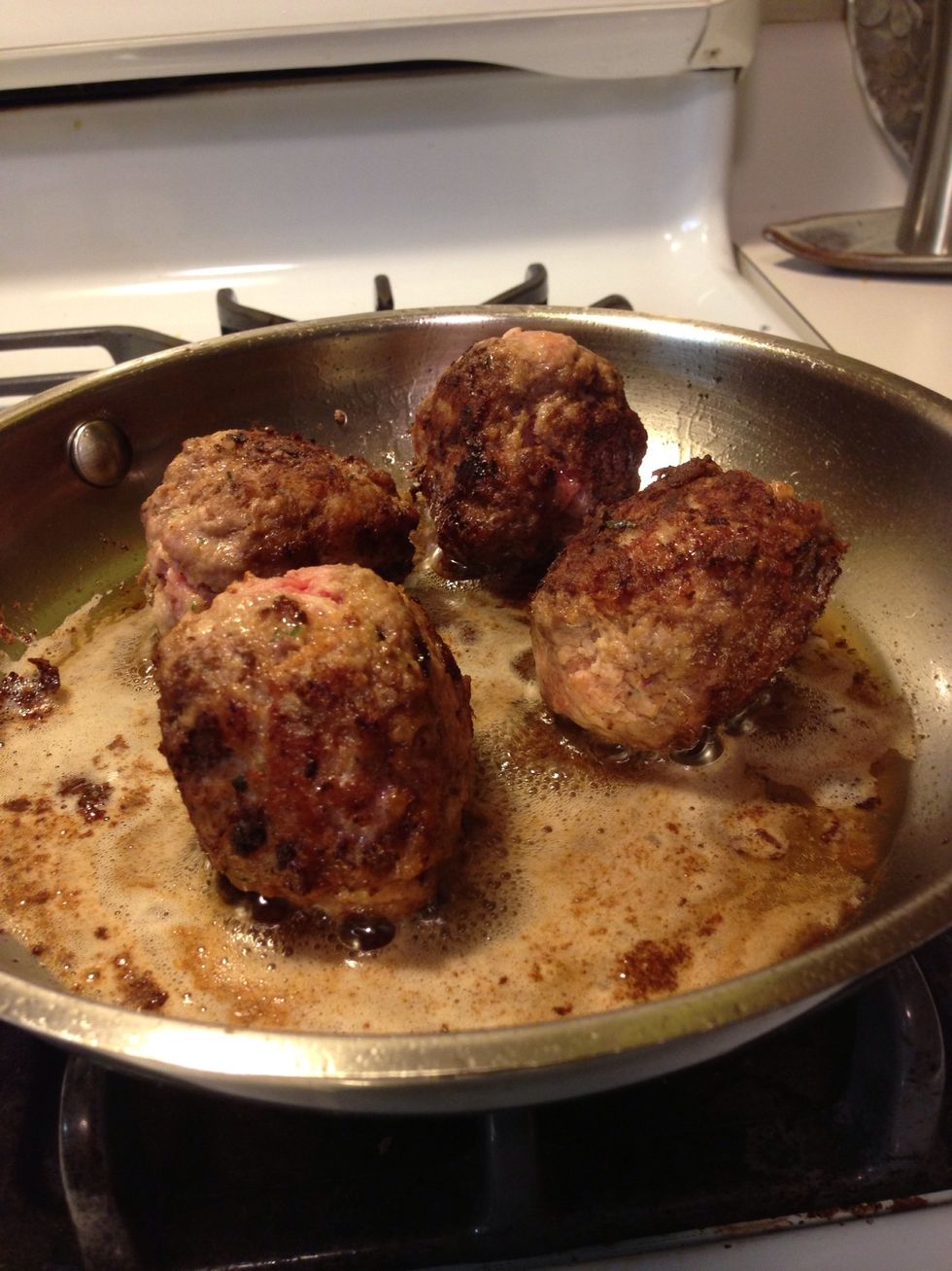 Almost there. See those bits of pink? We need to make sure the entire outside is seared well. Don't worry about getting the meatball cooked all the way through yet. We'll do that next.