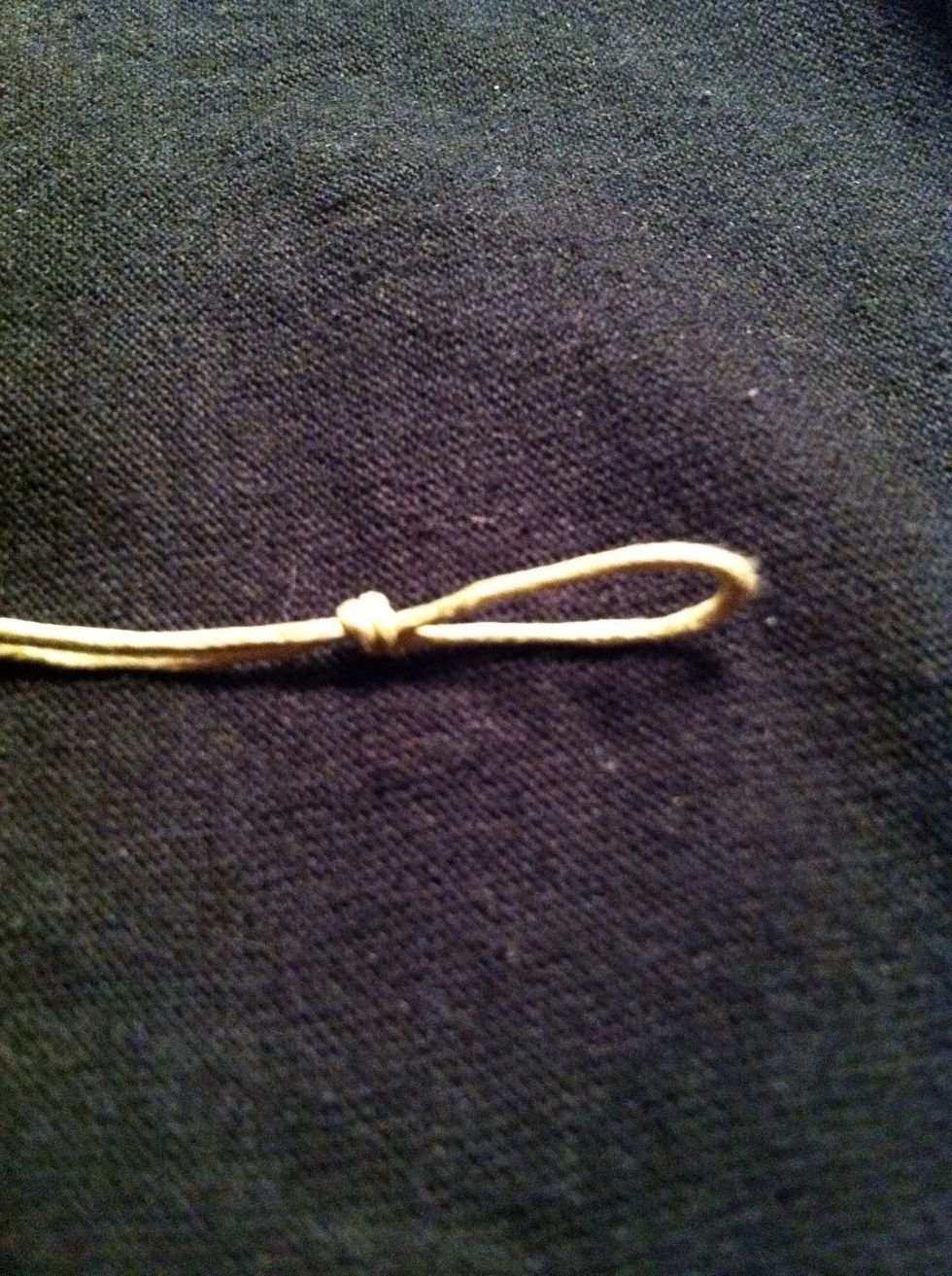 Alright, knot tied and bead removed. You should have this \ud83d\udc46(sorry its so blurry and bright! Yikes!!)