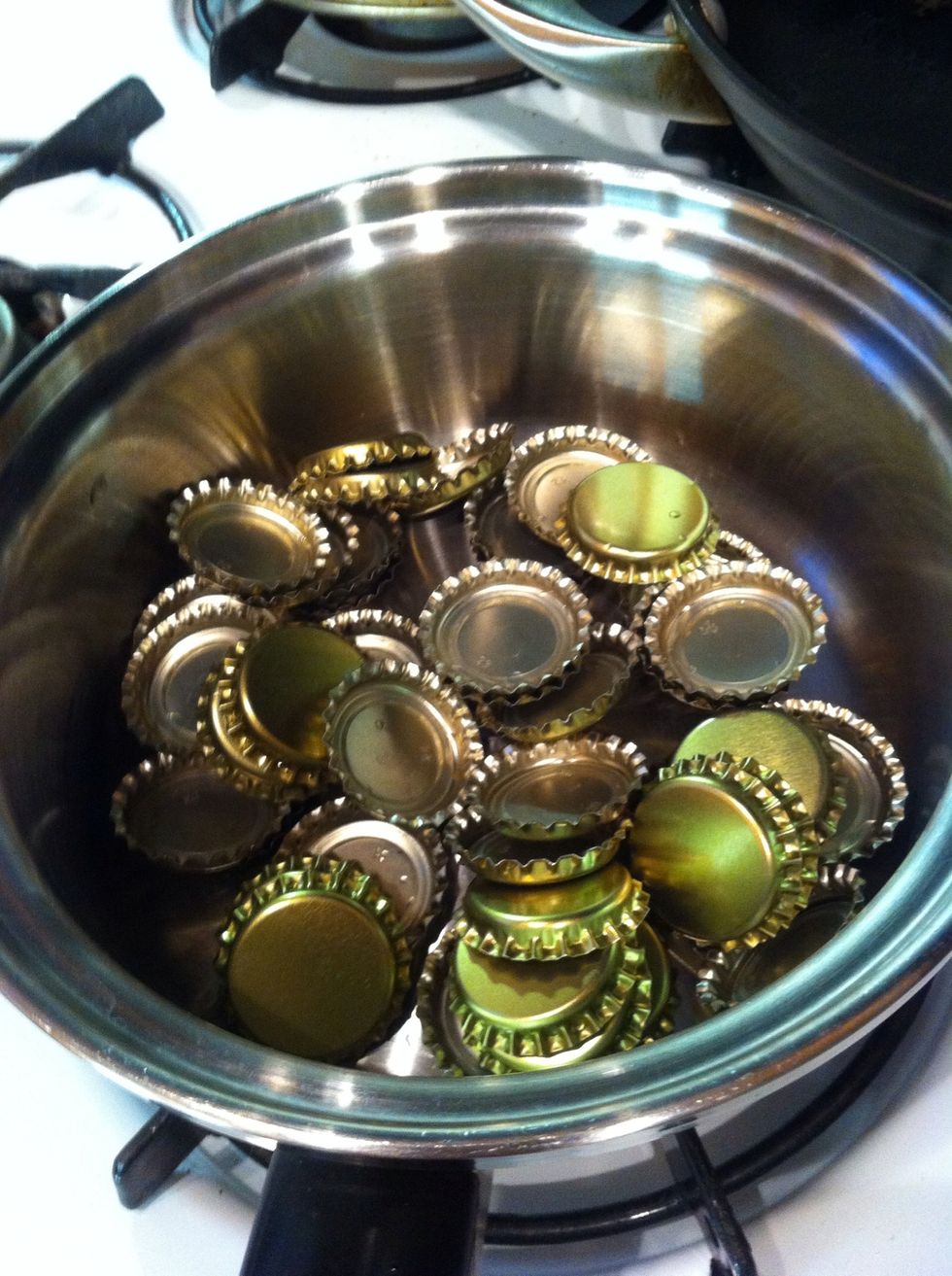 alright sons of man. you have all your bottles filled. now boil like 4 cups of water. as soon as it boils turn the flame off and dump your bottle caps in. this is enough to sanitize these.