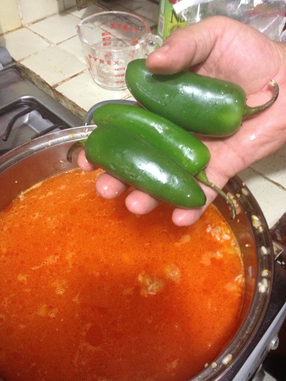 Also add the jalape\u00f1os, whole so the rice won't be so spicy.