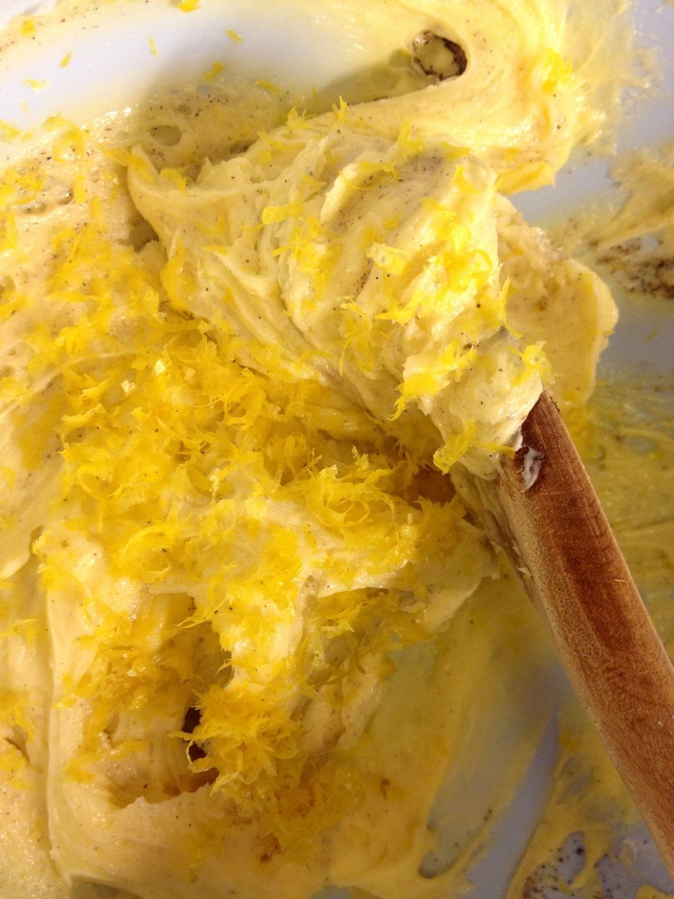 Also add the lemon peel. Stir. Now you add the flour and baking powder as well.