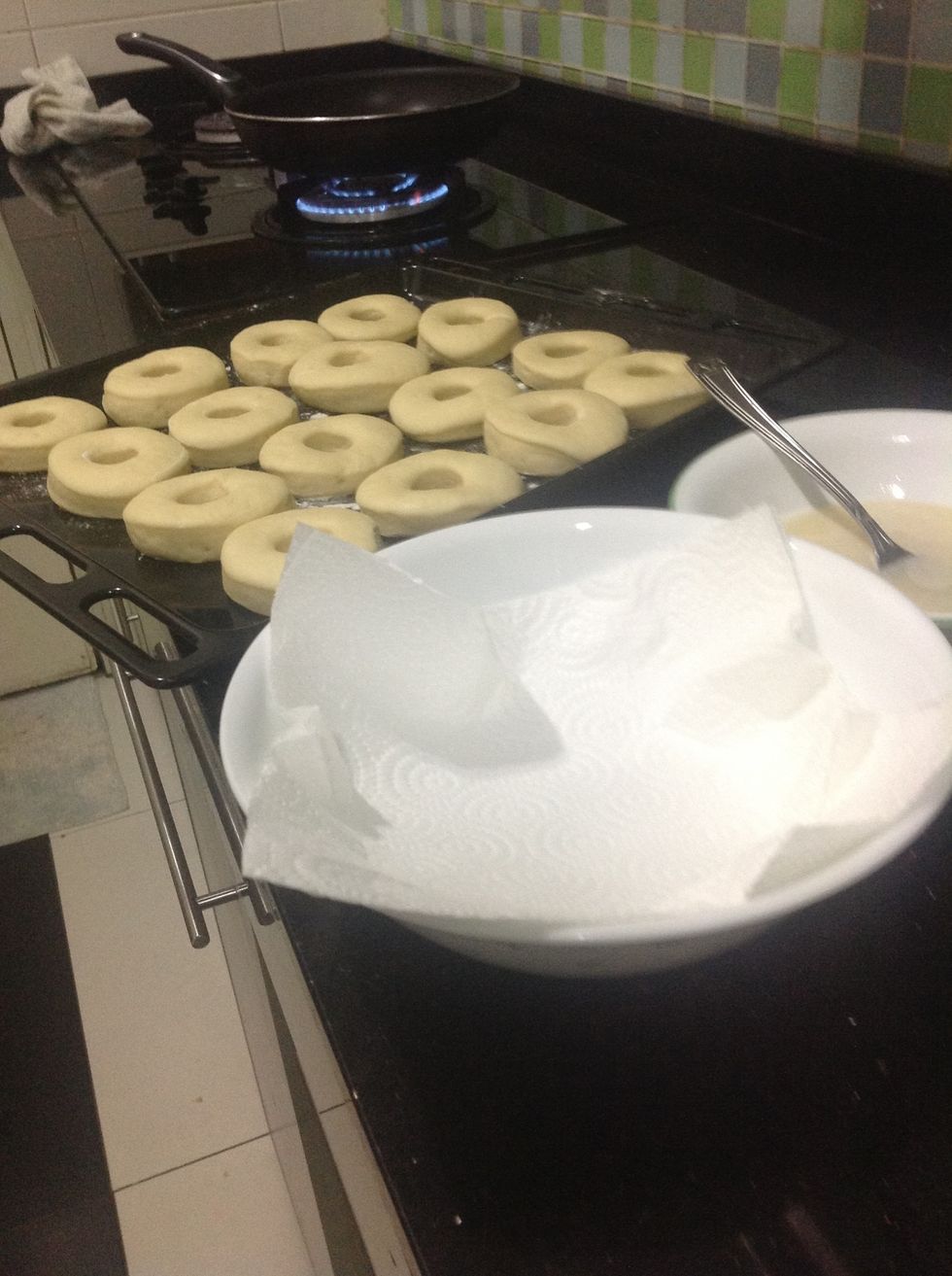 Also get a large bowl and place some more kitchen towel in it, so it absorbs the excess oil from the doughnuts.