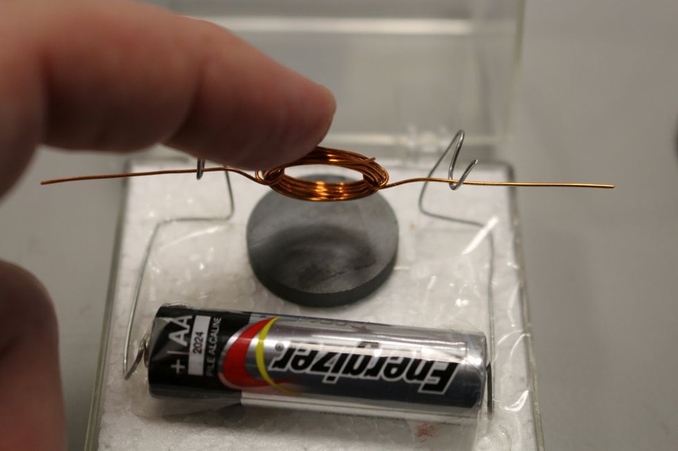 Also make sure your coil does NOT touch the magnet - it has to be right over it so it can spin around. Give it a flick with your finger to spin it around...