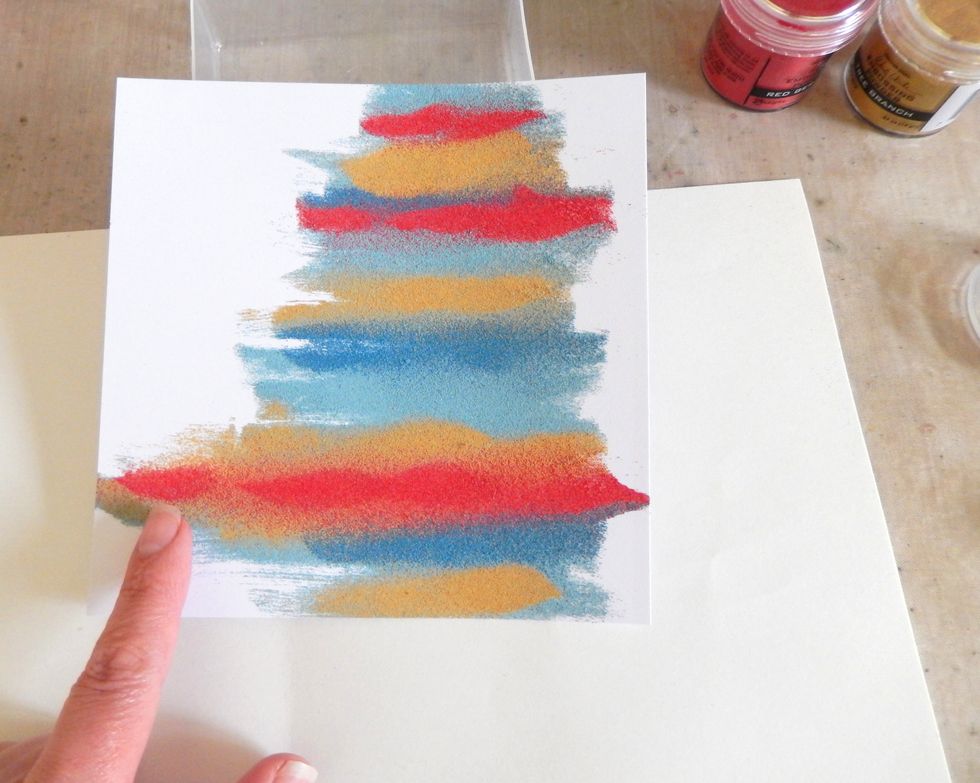 Alter straight edges by gently removing any excess powder with your finger. Now heat set the embossing powder with a heat gun. If your background warps mist it with water and place under heavy books.