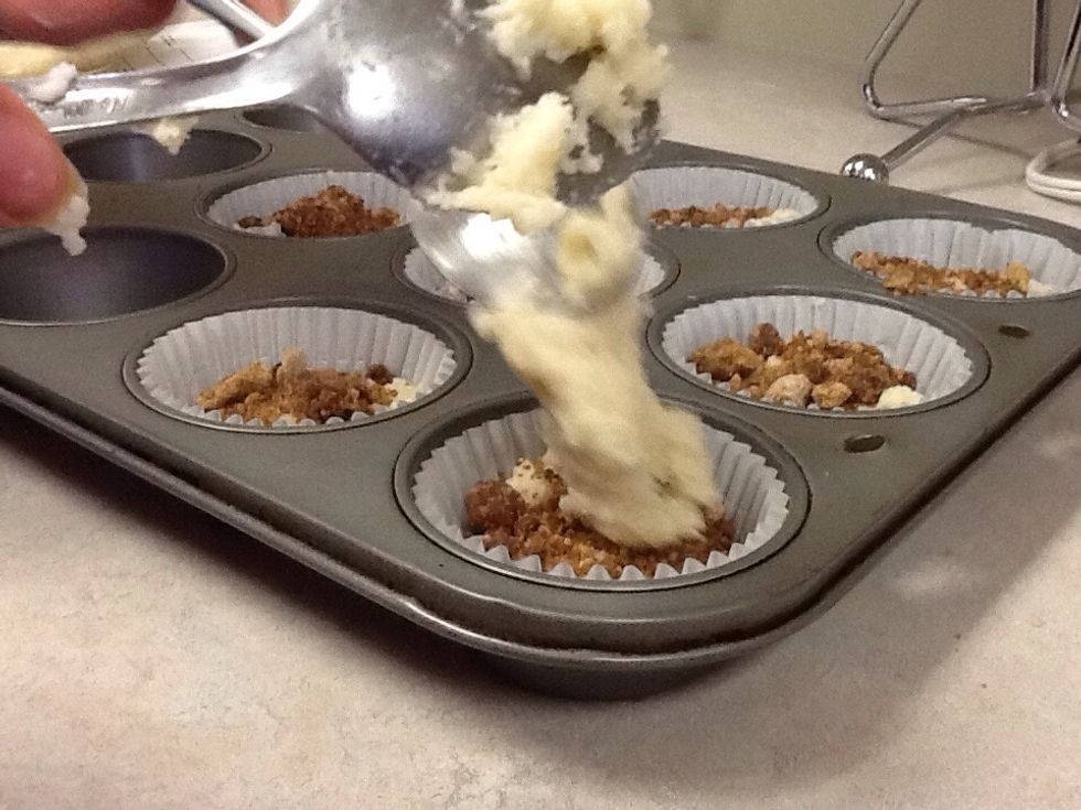 Alternate layers of battery and spicy topping to make eight muffins.
