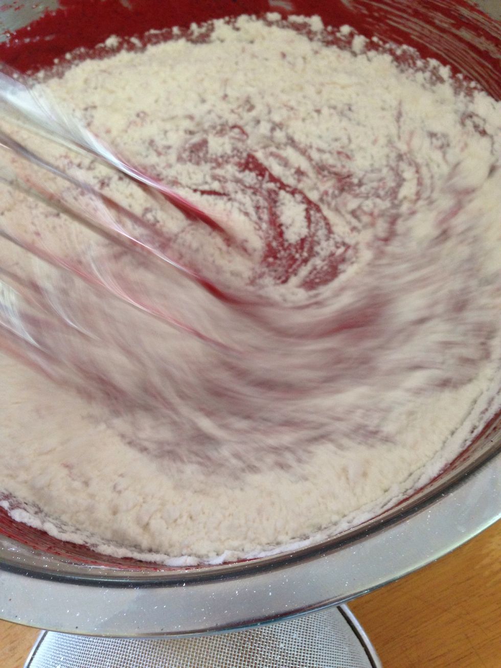 Alternately and slowly Add flour and milk to the red mixture