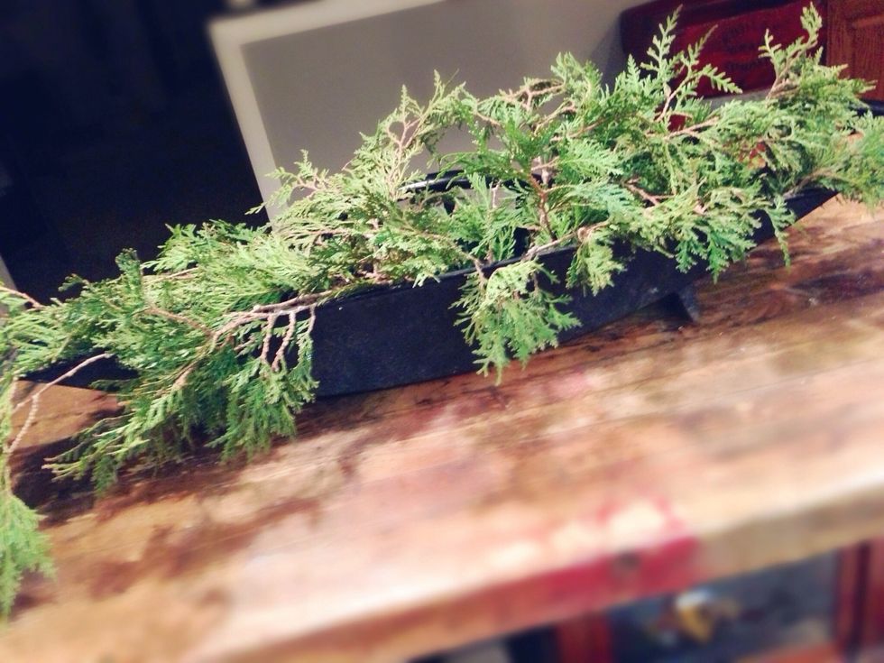 Always start an arrangement with the perimeter! Use evergreen leaves to form a "wreath" around the edges of the vessel.