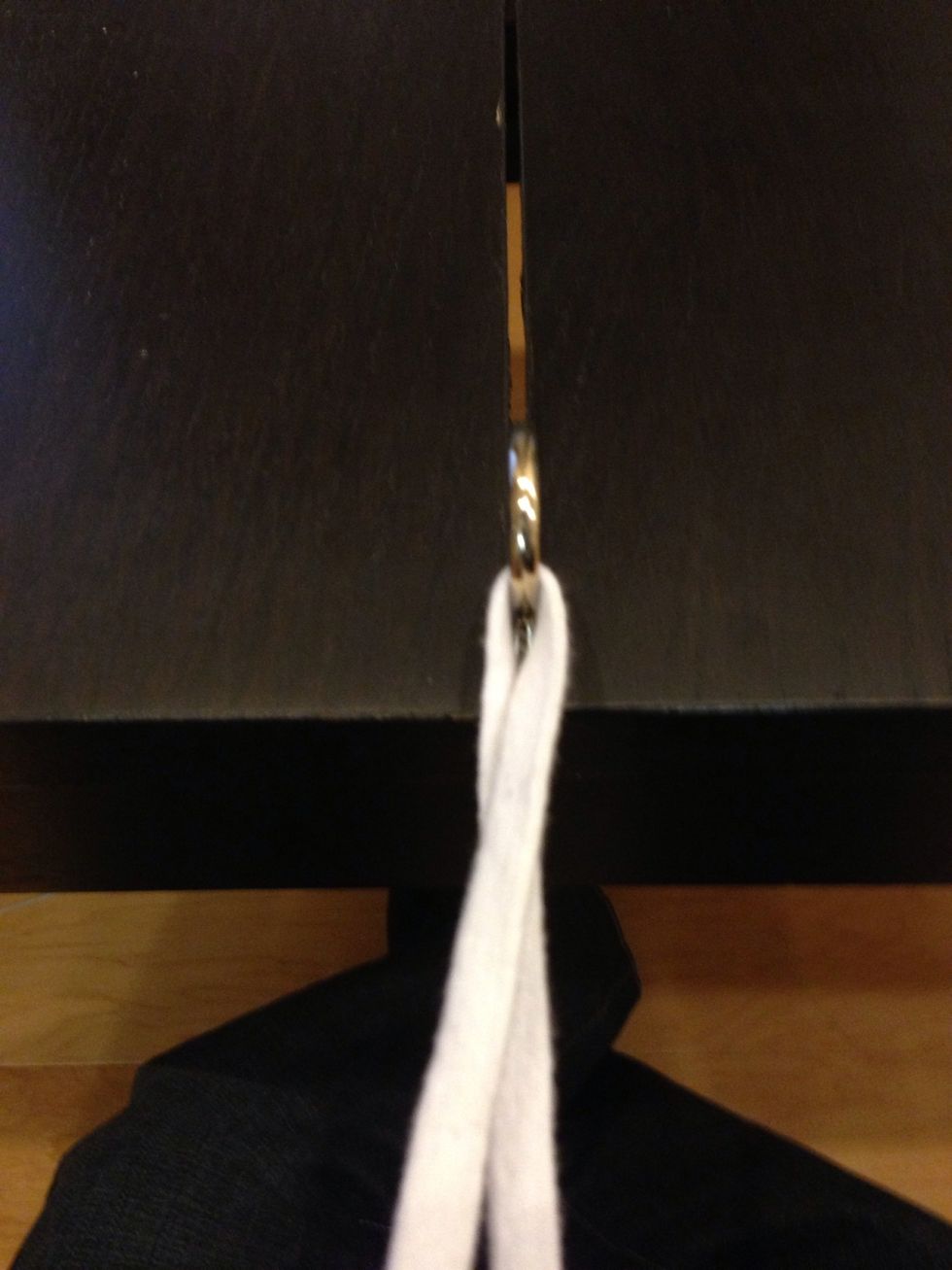 ALWAYS START WITH YOUR SUTURE CROSSED. This will ensure a flat and square knot. The "throwing" hand (left hand) is holding the part of the suture on "top". Note that the suture is crossed at the hook.