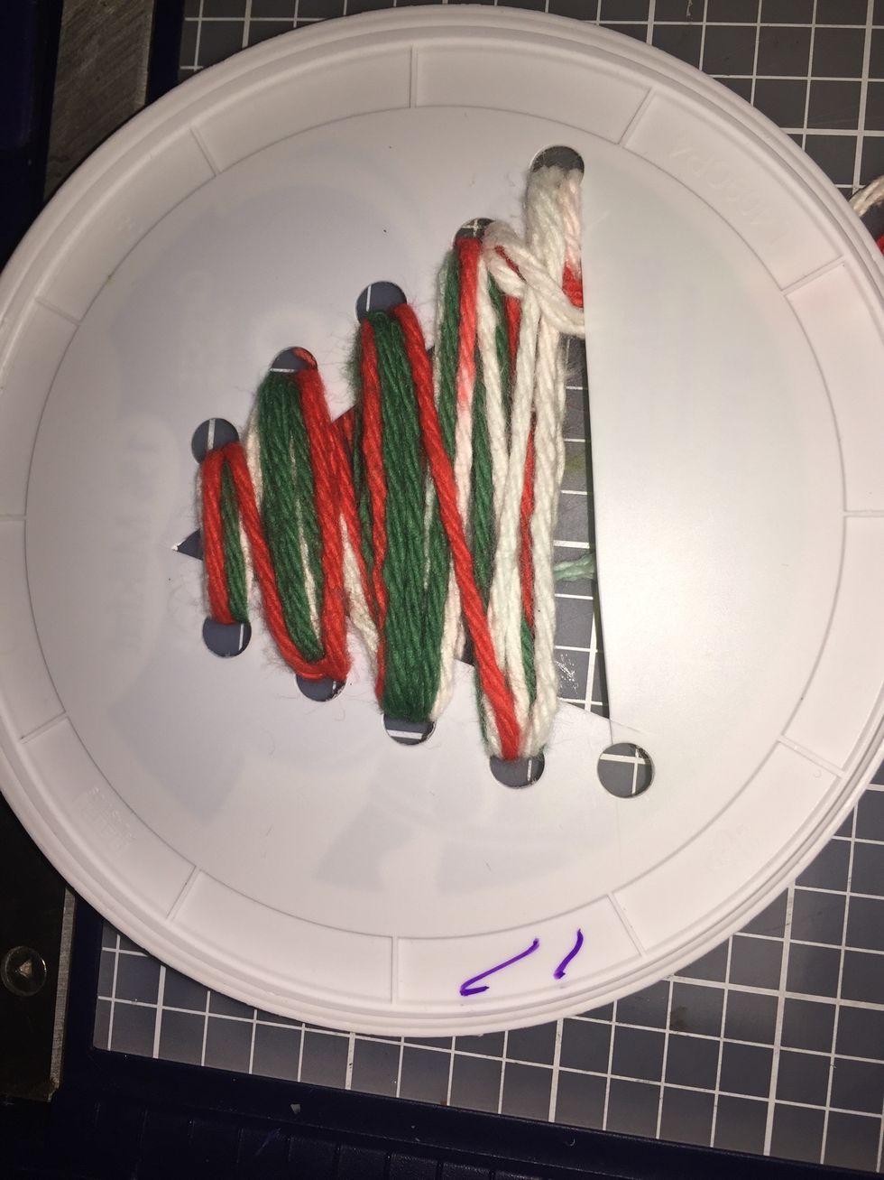 An example of one w/ all the yarn. (You see how the one hole was too close to the triangle so would not hold yarn in) I got red, green, and white yarn to add color but was reminded trees are green.