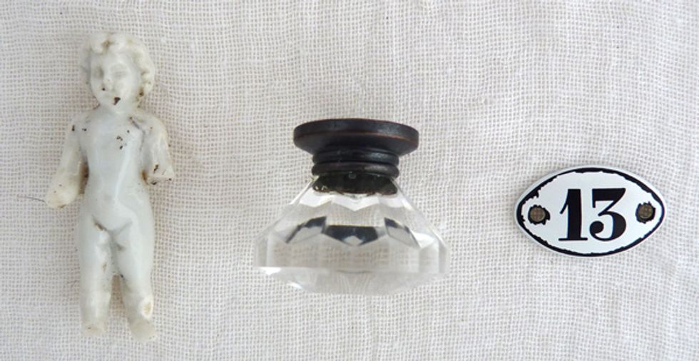 An original vintage Charlotte doll, a glass knob and a mini number plaquette.