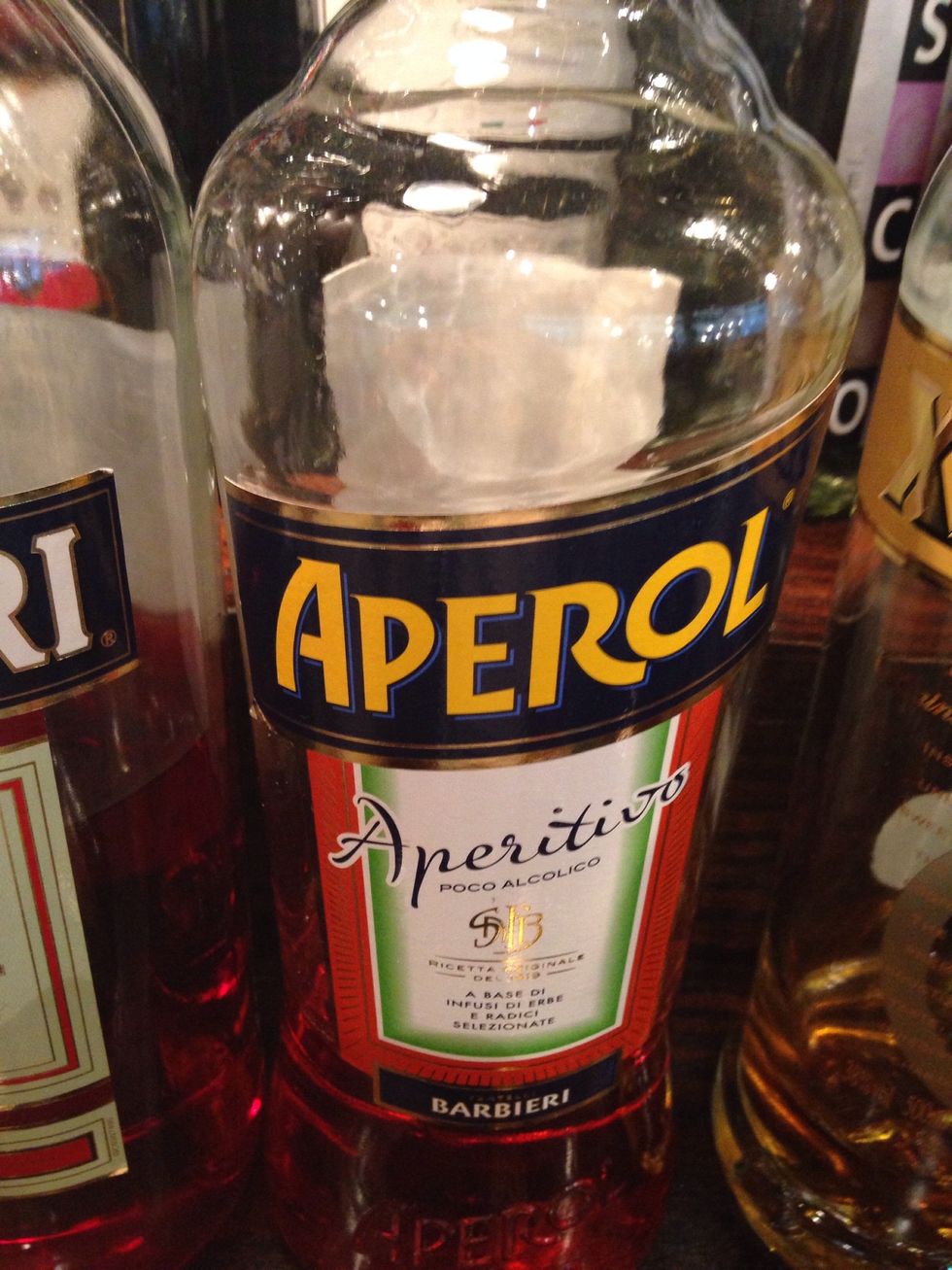 And 20ml (3/4oz) of Aperol with a dash of sugar syrup. Give it a good shake, breaking up the fruit and combining the liquid ingredients.