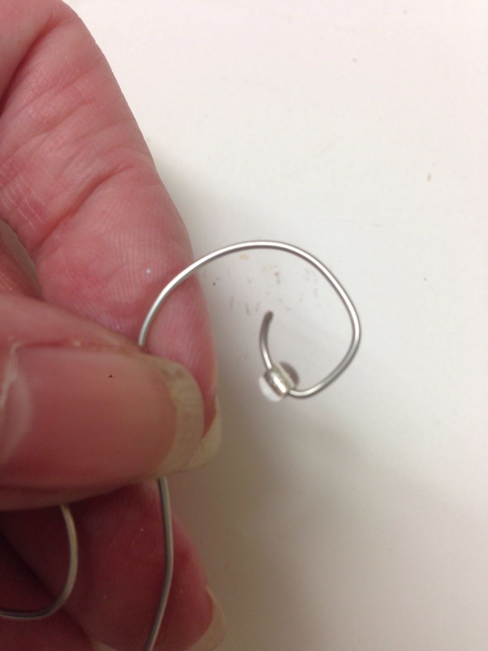 And a bead to the bent end of the hanger.