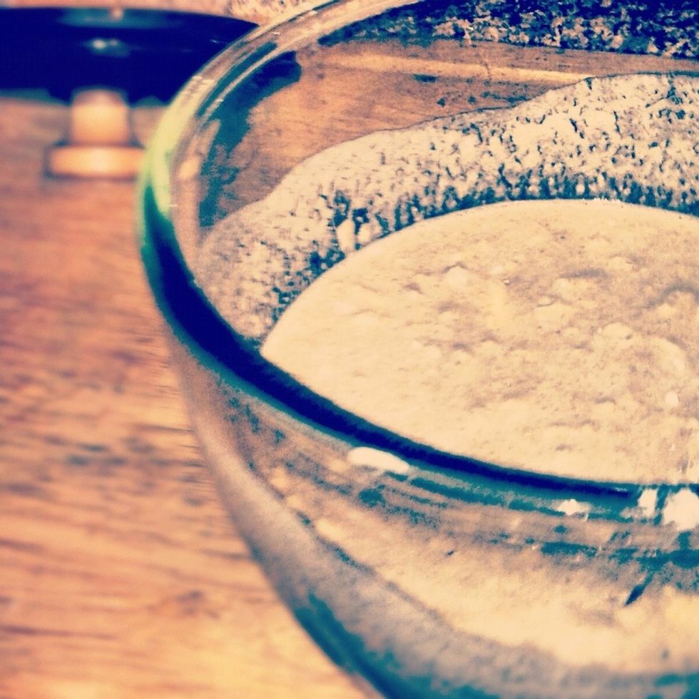 And add your flour and salt Mix until the dough isn't sticking to the sides Lumps are ok but it should be relatively uniform A standing mixer and bread hook would be handy here but I am a poor purist