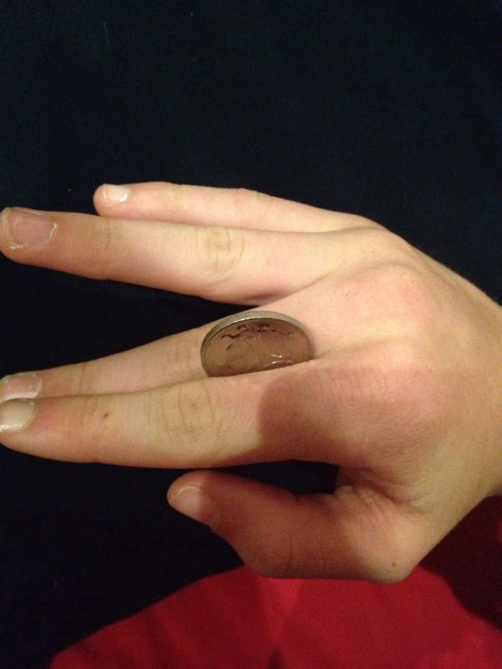 And at the same time raise you index finger to help roll the coin over