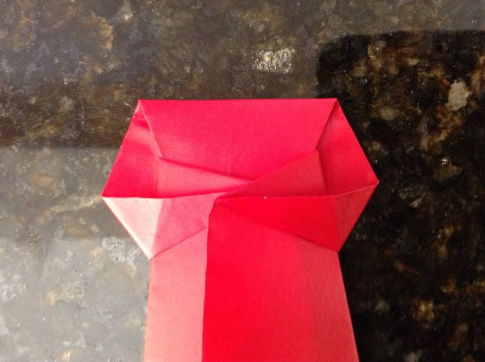 And fold it behind the two corners.