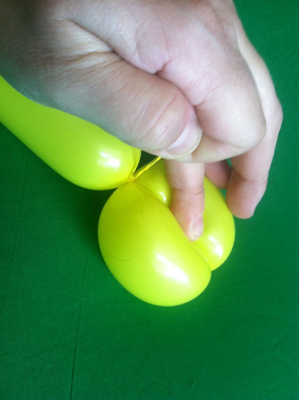 And fold it onto the rest of the balloon creating ado double bubble set. Tie it off by wrapping the nozzle in and out of the seam