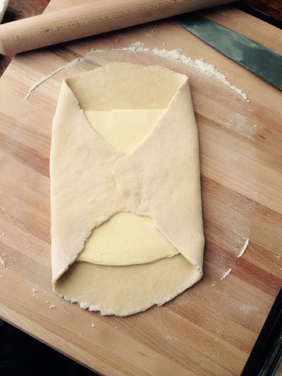 And fold the dough over closing it at the center.