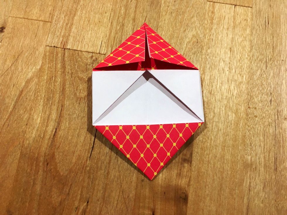 And fold the top two corners so they meet closer to the center