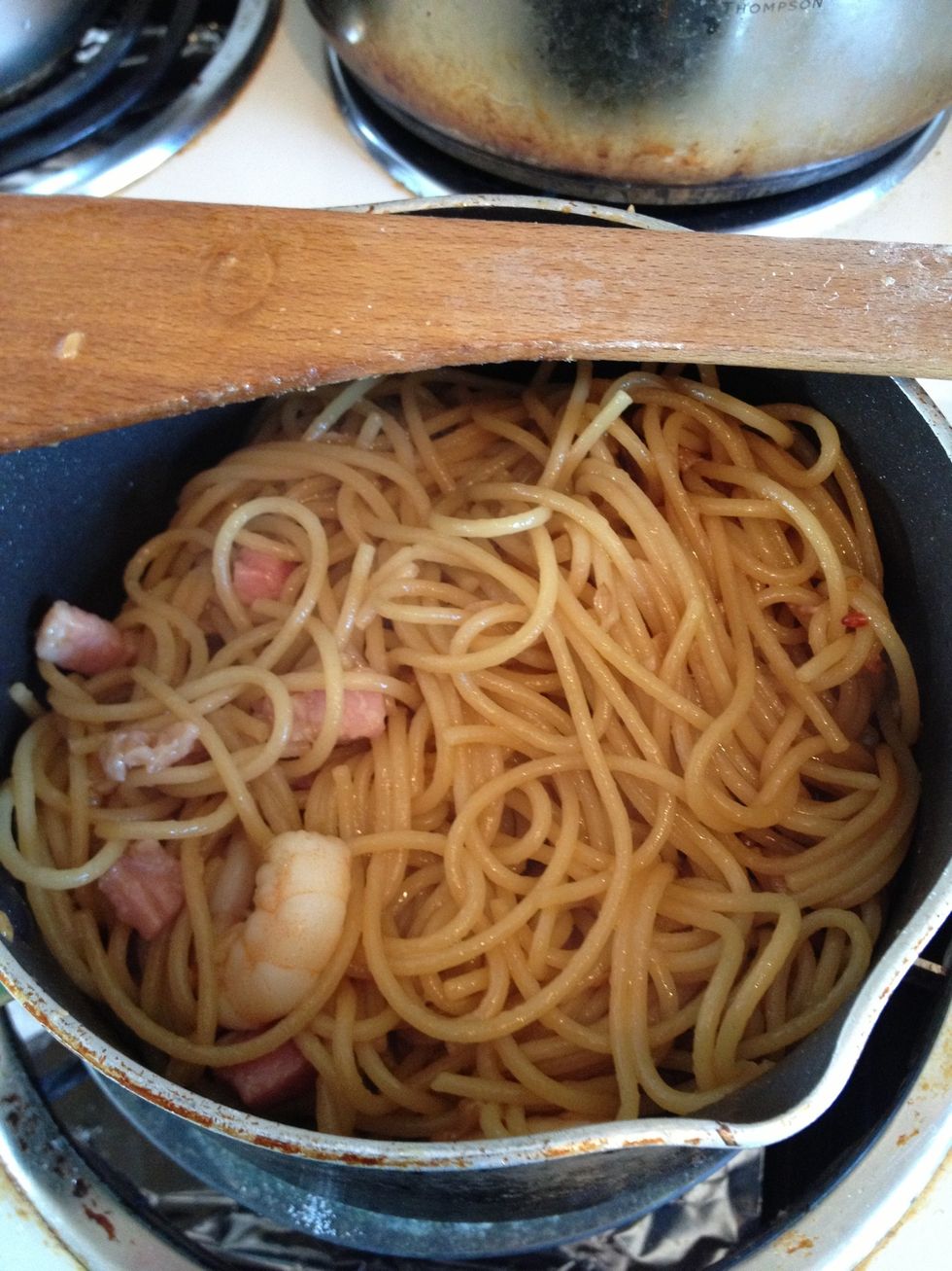 And frying, until bacon and prawns are cooked