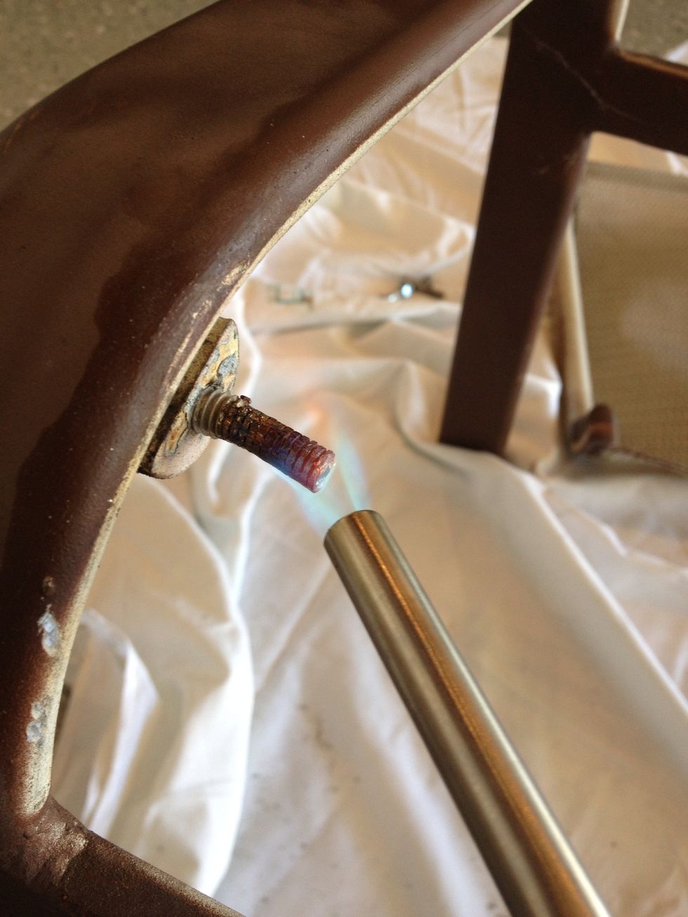And heating again!!  Then letting it cool and take the vice grips to it again.  The goal is to break up the corrosion between, in this case, the steel bolt and the aluminum lawn furniture.