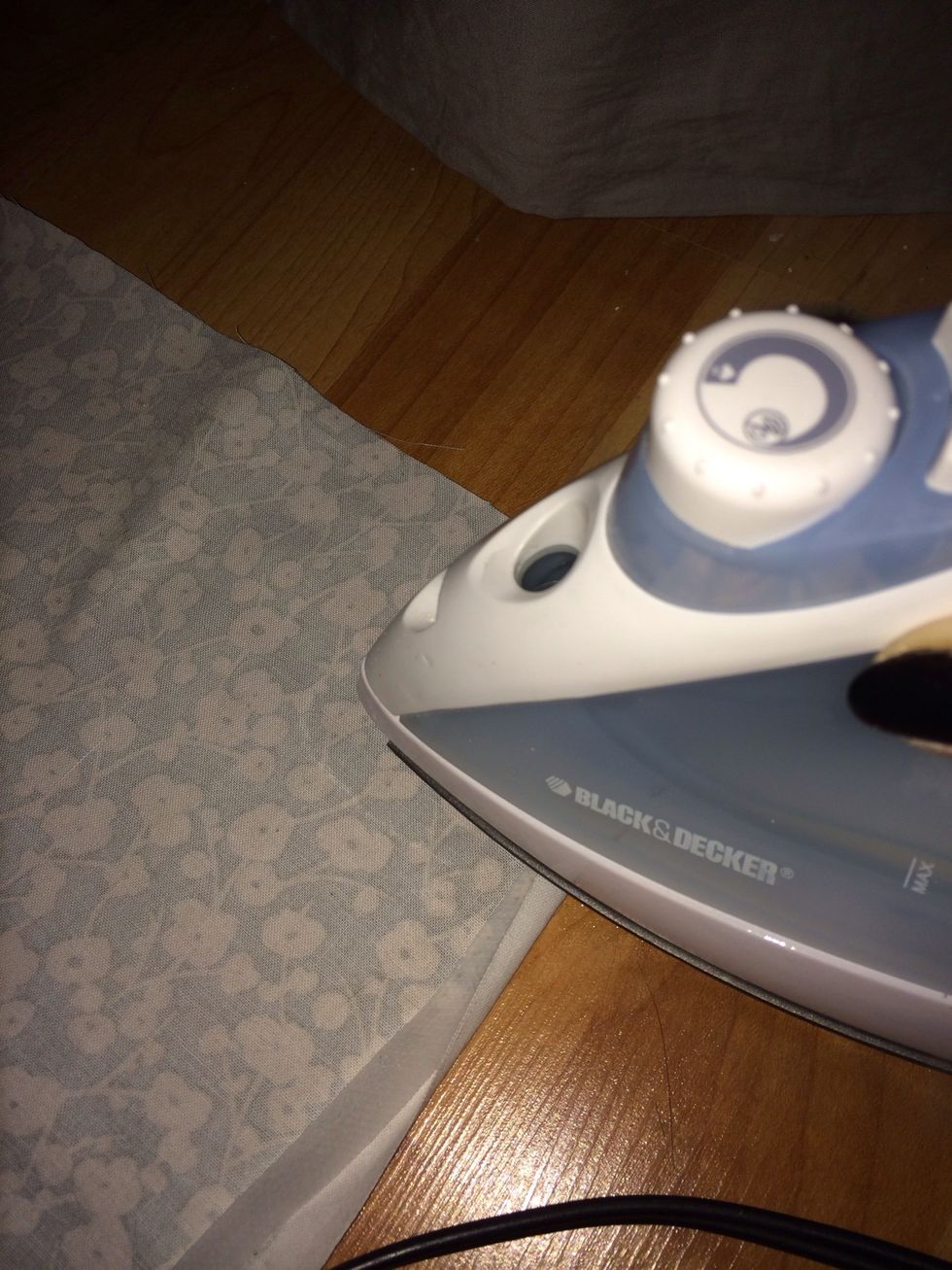 And iron down folded fabric. Hold down for about 2-3 seconds or until tape has adhered to the fabric.