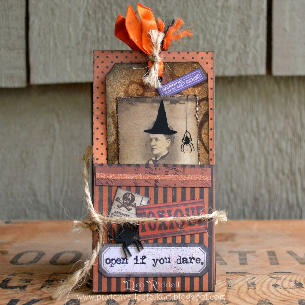 And last but not least, insert your tags into the pockets, fold up your Halloween accordion tag folder and secure closed with some jute twine tied through the eyelets. Happy Halloween! Deb xo